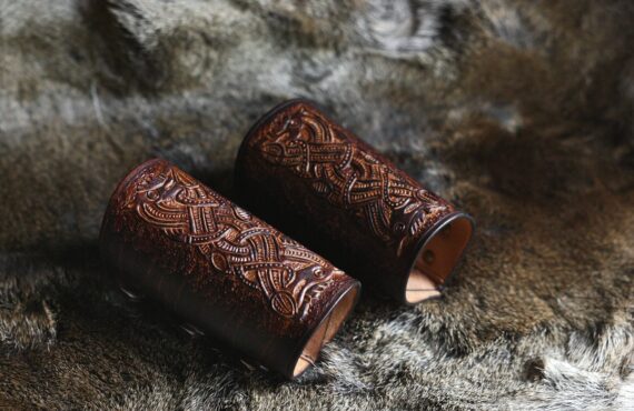 Long dark brown leather wrist cuffs on the hairy hide.