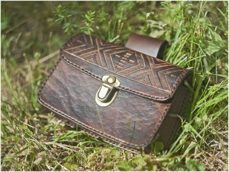 Belt pouch with carved folk pattern