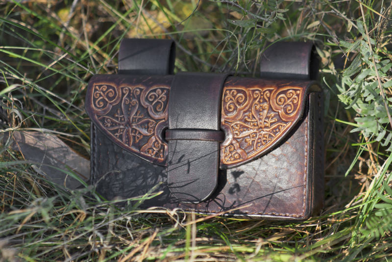 Dark brown leather belt pouch with curvy pattern