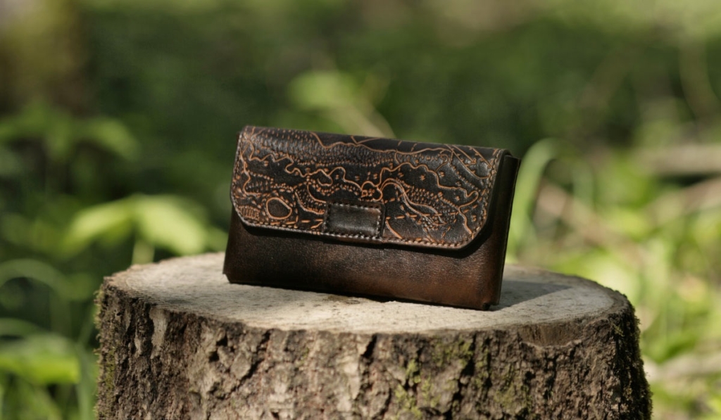 Leather belt bag with magnet lock, decorated by hand carved orienteering map