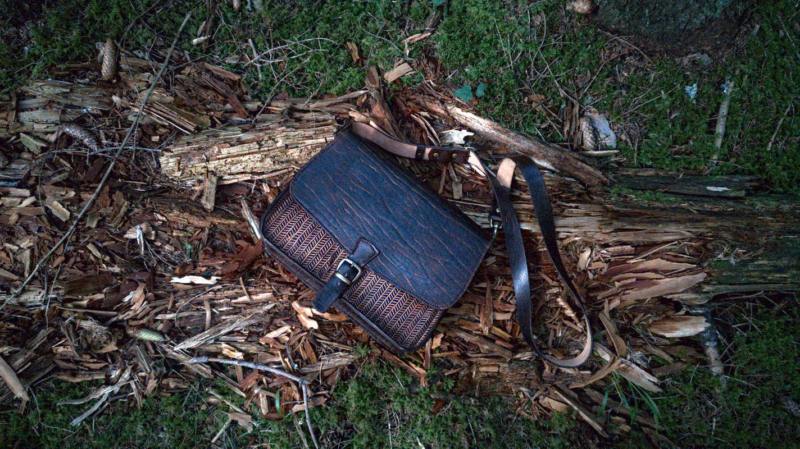 Dark brown leather shoulder bag, decorated by hand carved herringbone pattern.