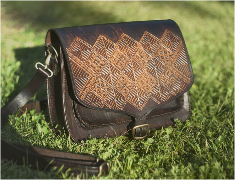 Dark brown shoulder bag with carved folk patterns