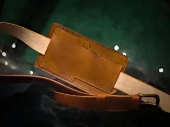 Medium brown leather bag from the back side (landscape style).