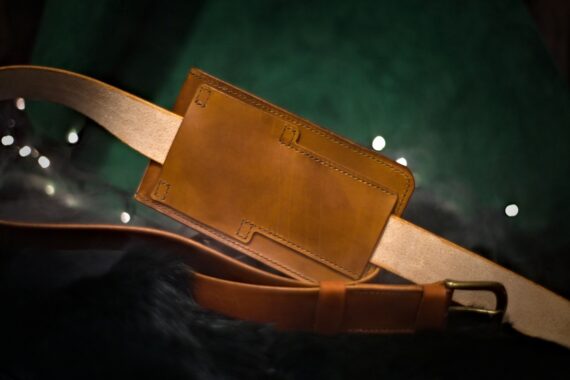 Medium brown leather bag from the back side (landscape style).
