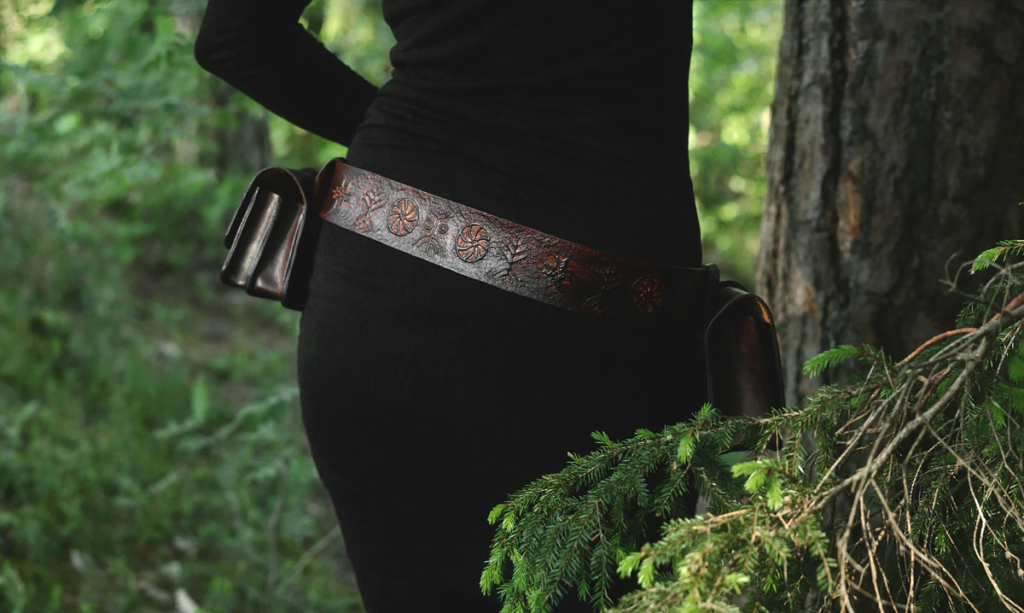 Belt and belt bags are decorated by hand carved archaic symbols that depict trees and wood.