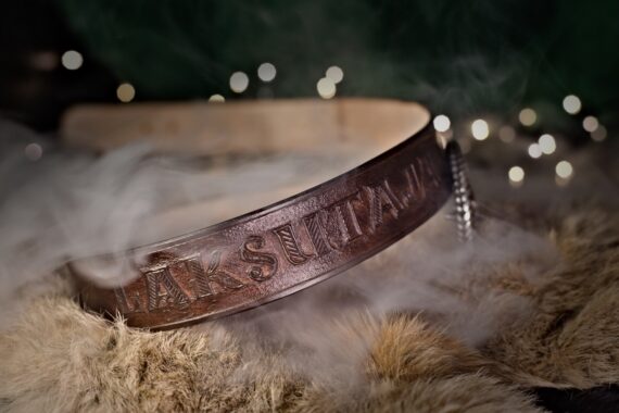Photo shows on the first hand the carving on the belt - how it is nicely multidimensional. Belt is dark brown and set onto the fur.