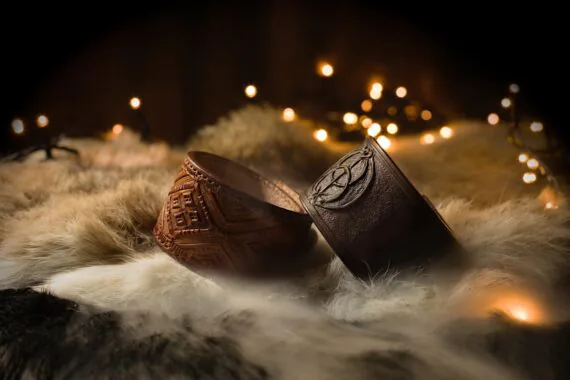 Light- and dark brown leather bracelet. Light brown bracelet is decorated by folk style pattern, dark brown features a Vesica Piscis sign.