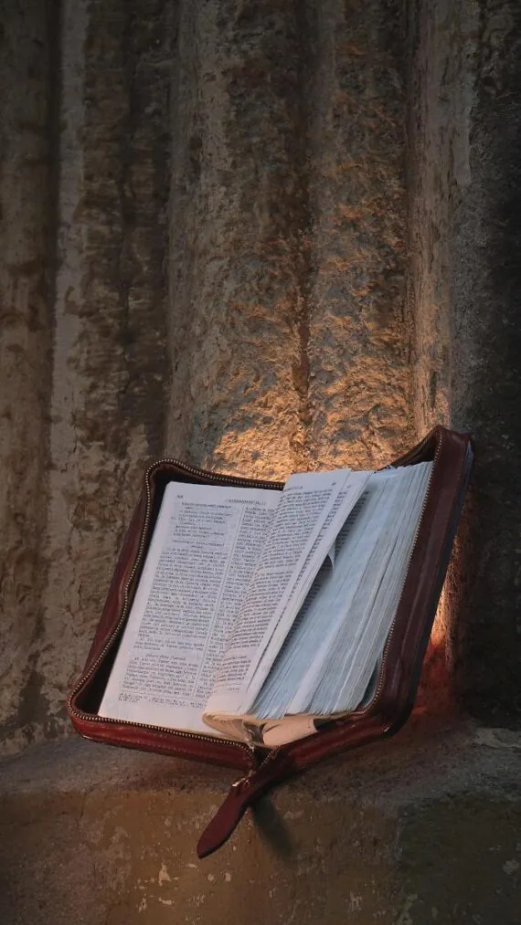 Covers are set onto grey stone edge. Covers are lighted also from the back and this gives to this image a kind of holy visual - very properly as these are covers for a pible.