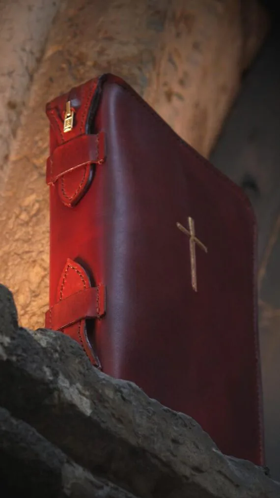 Covers are set onto grey stone edge. There are some lighter curved forms on the background.