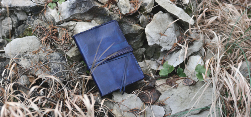 Blue leather notebook covers with strap tie down