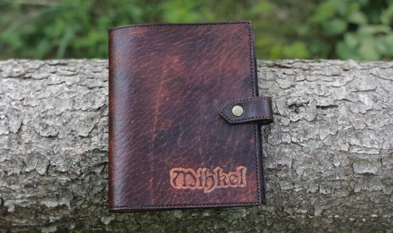 Dark brown notebook covers with carved name