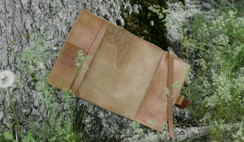 Leather notebook covers with natural finish, decorated by hand carved ornament.