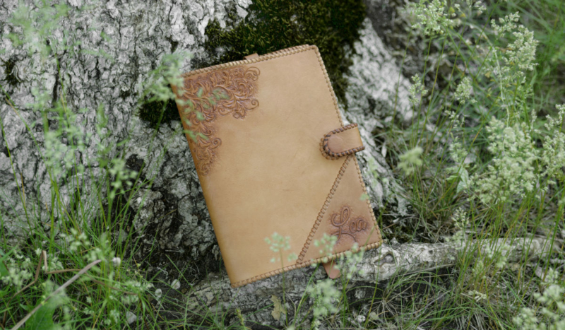 Leather notebook covers with natural finish, decorated by hand carved ornament.
