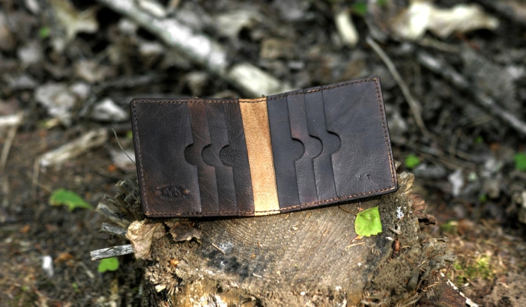 Dark brown carved leather card case with eight pockets.