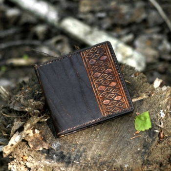 Dark brown carved leather card case with eight pockets.