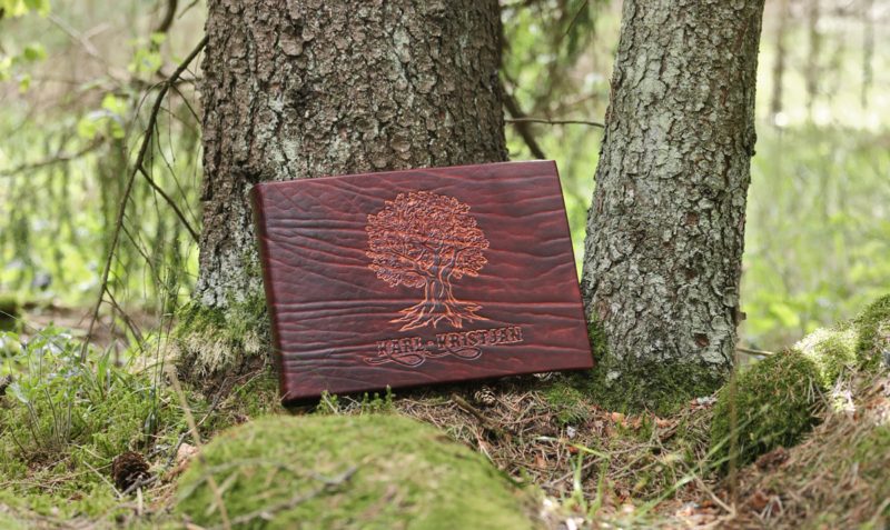 Leather cased photo album with caved oak tree