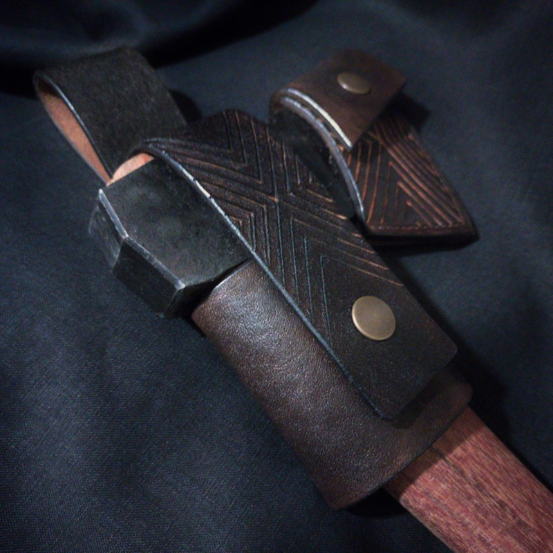 Leather axe sheath and belt loop set in dark brown. Decorated by herringbone pattern.