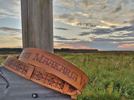 Two wide collars set onto the fence post. Collars are decorated by pyrography technique - by some pattern and text.